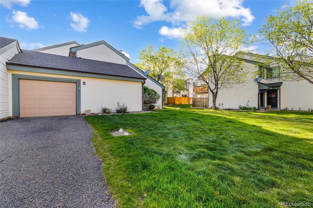 view of side of property featuring a garage and driveway