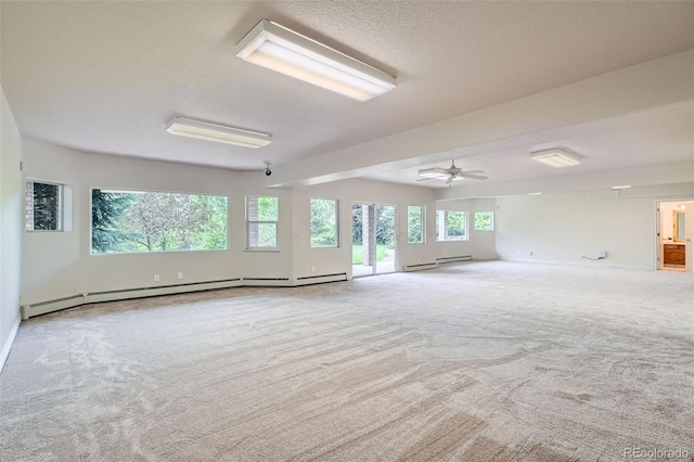 6335 Oberon Rd, Arvada, CO 80004 - empty room with carpet floors, a textured ceiling, baseboard heating, and baseboards