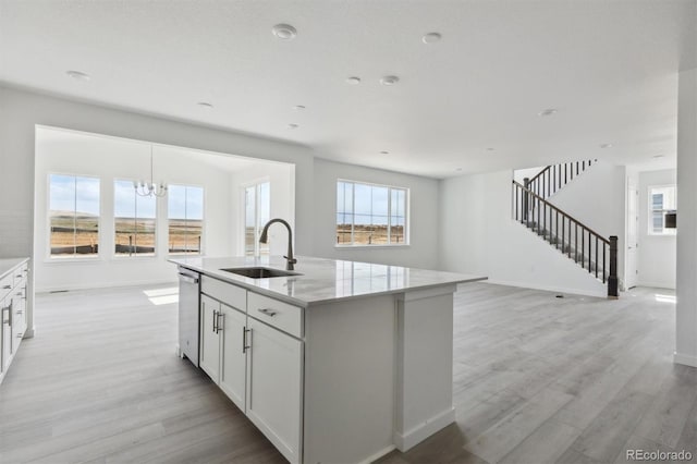 25234 E Warren Pl, Aurora, CO 80018 - kitchen with a sink, light wood-type flooring, dishwasher, and plenty of natural light