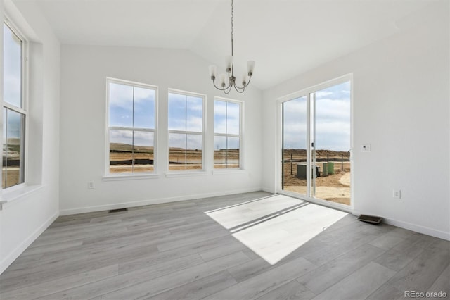 25234 E Warren Pl, Aurora, CO 80018 - unfurnished dining area featuring a chandelier, lofted ceiling, light wood-type flooring, and baseboards