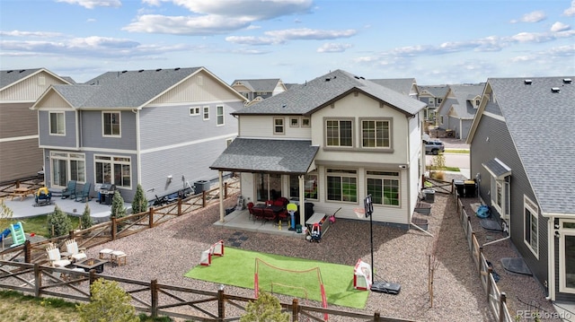 back of property with a residential view, a shingled roof, a fenced backyard, cooling unit, and a patio