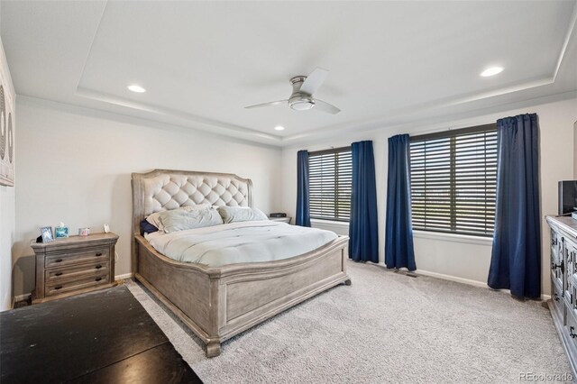 bedroom featuring recessed lighting, baseboards, light colored carpet, and a raised ceiling