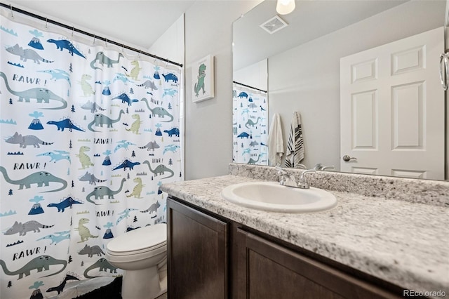 bathroom featuring vanity, toilet, curtained shower, and visible vents