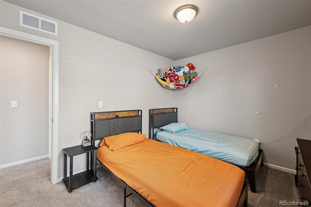 carpeted bedroom with baseboards and visible vents
