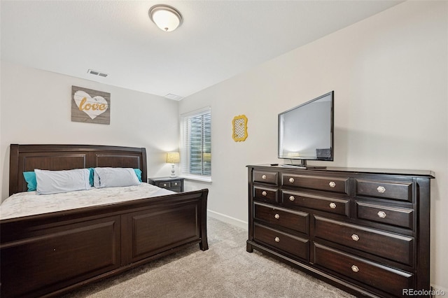 bedroom featuring visible vents, baseboards, and light colored carpet