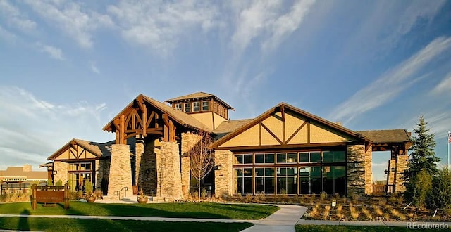 exterior space with a lawn and stone siding