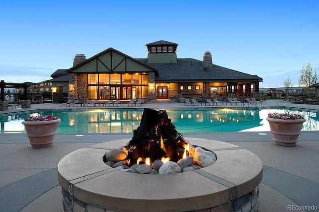 view of pool with a patio, a fenced in pool, and an outdoor fire pit