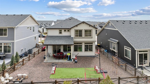 rear view of house with central AC, a fenced backyard, roof with shingles, a patio area, and a residential view