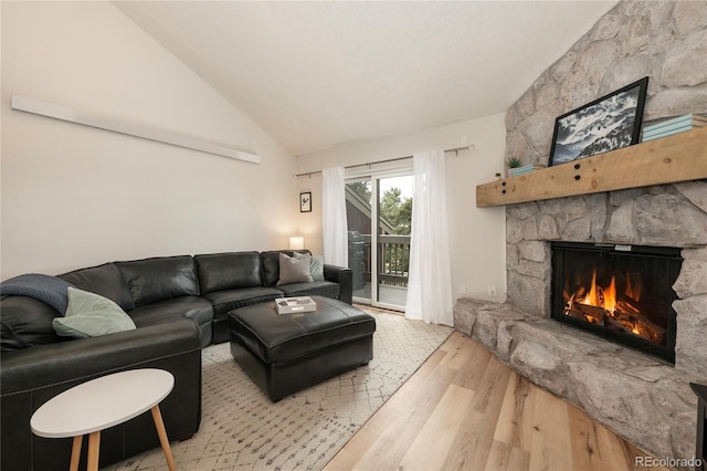 62 County Road 838 Unit 21-4, Fraser, CO 80442 - living area featuring wood finished floors, a stone fireplace, and lofted ceiling