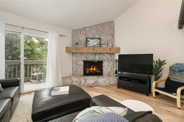 62 County Road 838 Unit 21-4, Fraser, CO 80442 - living room featuring vaulted ceiling, wood finished floors, and a fireplace