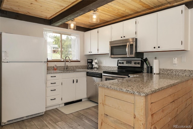 62 County Road 838 Unit 21-4, Fraser, CO 80442 - kitchen featuring stainless steel appliances, wooden ceiling with exposed beams, a sink, white cabinets, and light wood-type flooring