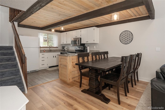 62 County Road 838 Unit 21-4, Fraser, CO 80442 - dining room with wooden ceiling with exposed beams, stairs, and light wood-type flooring