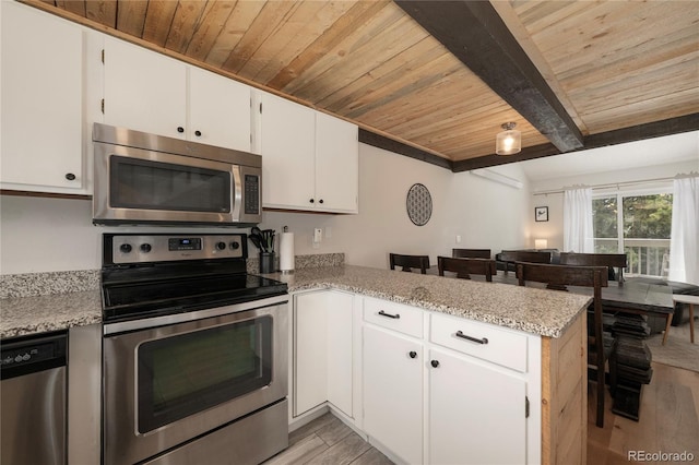 62 County Road 838 Unit 21-4, Fraser, CO 80442 - kitchen featuring appliances with stainless steel finishes, wooden ceiling with exposed beams, light wood finished floors, a peninsula, and white cabinets