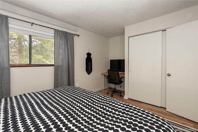 62 County Road 838 Unit 21-4, Fraser, CO 80442 - bedroom with wood finished floors, a textured ceiling, and a closet