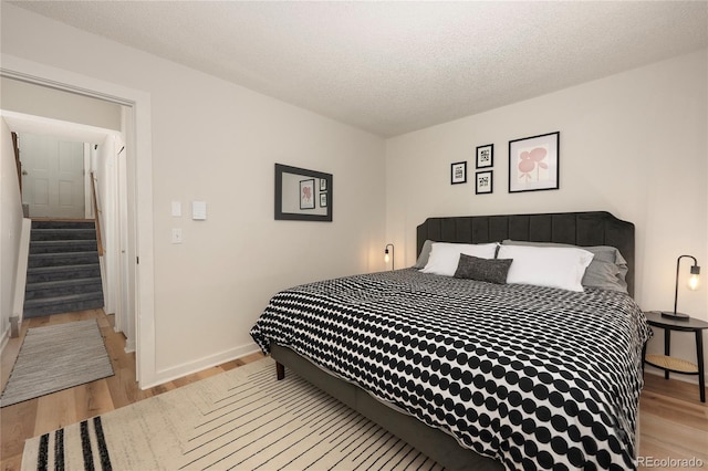 62 County Road 838 Unit 21-4, Fraser, CO 80442 - bedroom with light wood-style flooring, baseboards, and a textured ceiling