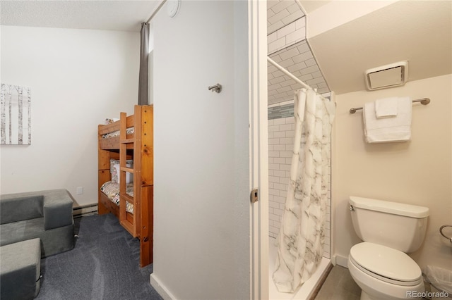 62 County Road 838 Unit 21-4, Fraser, CO 80442 - full bathroom featuring a shower stall, a baseboard heating unit, and toilet