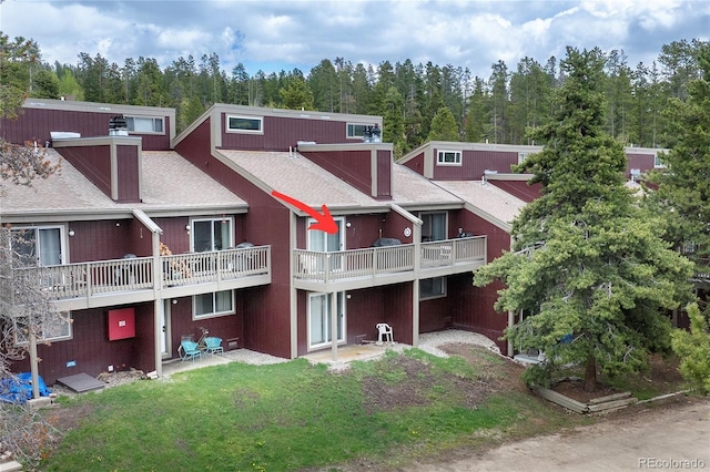 62 County Road 838 Unit 21-4, Fraser, CO 80442 - rear view of house featuring a yard, a chimney, roof with shingles, and a patio