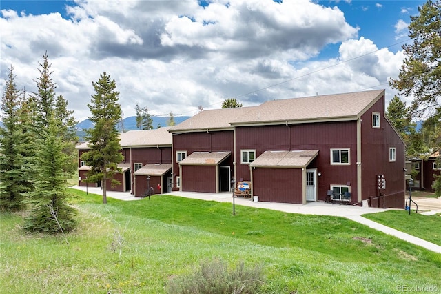 62 County Road 838 Unit 21-4, Fraser, CO 80442 - rear view of house with a lawn, an outdoor structure, and a shingled roof