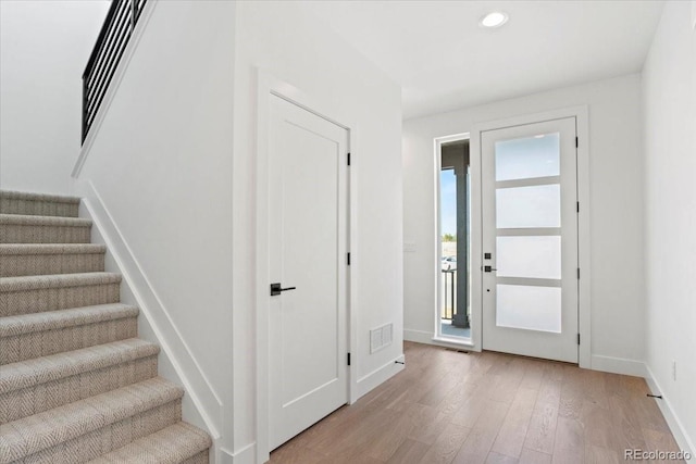 5595 Wheaton Ave, Longmont, CO 80503 - entrance foyer featuring light wood-style floors, stairway, and recessed lighting