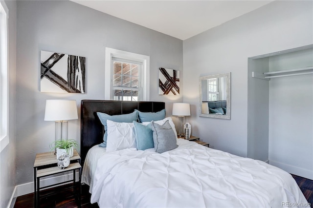 bedroom with a closet and dark hardwood / wood-style flooring