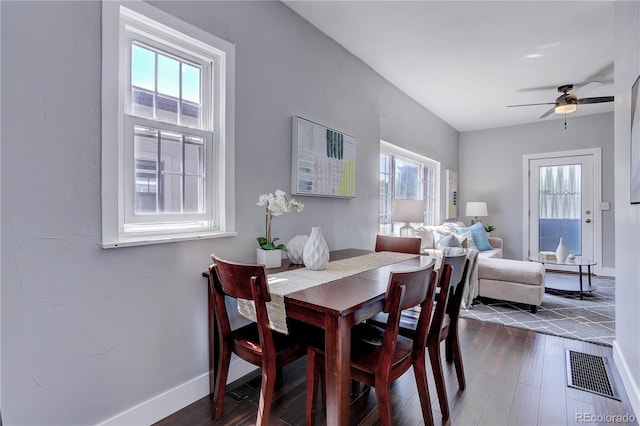 dining room with plenty of natural light, ceiling fan, and dark hardwood / wood-style floors