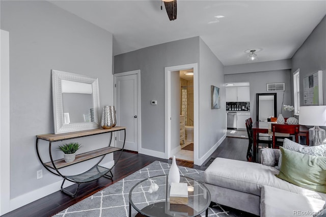 living room with ceiling fan and dark hardwood / wood-style floors