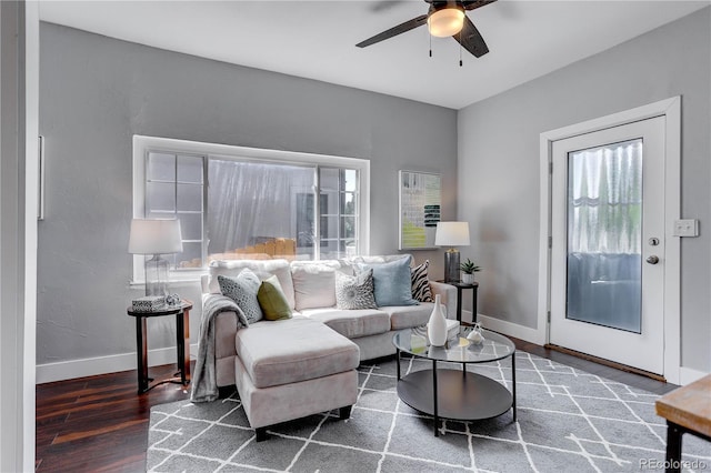 living room with ceiling fan and dark hardwood / wood-style floors