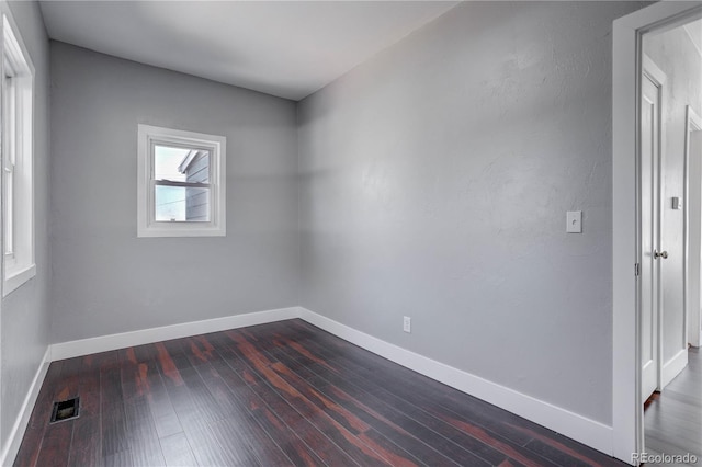 unfurnished room featuring dark hardwood / wood-style floors