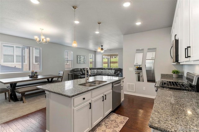 kitchen featuring appliances with stainless steel finishes, sink, white cabinetry, and an island with sink