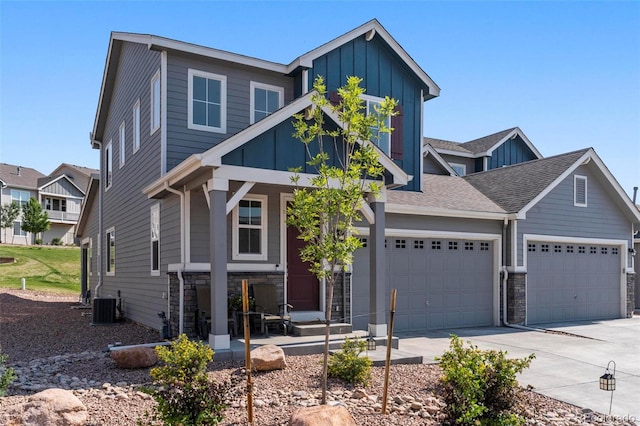 view of front of home featuring cooling unit and a garage