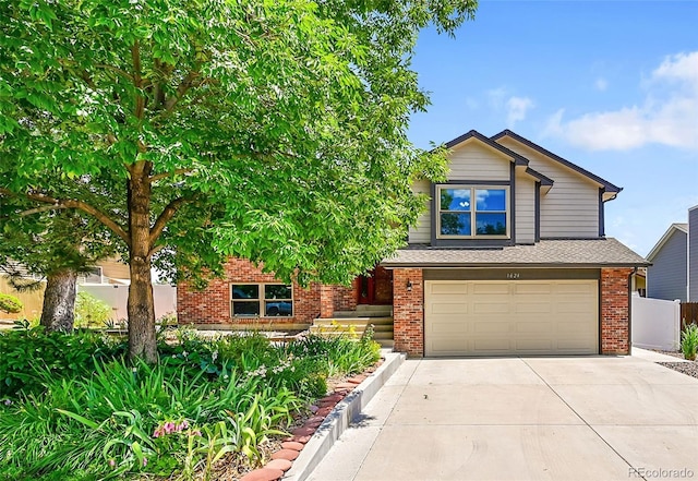 1624 Daphne St, Broomfield, CO 80020 - view of front facade with brick siding, an attached garage, and concrete driveway