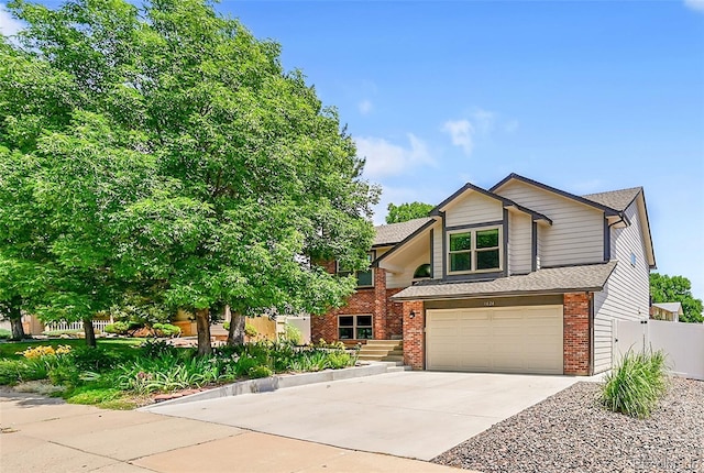 1624 Daphne St, Broomfield, CO 80020 - view of front facade with brick siding, an attached garage, and concrete driveway