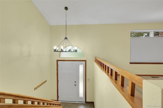 1624 Daphne St, Broomfield, CO 80020 - entrance foyer featuring stairway, carpet flooring, and a chandelier