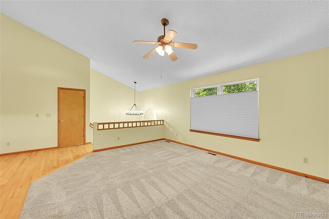 1624 Daphne St, Broomfield, CO 80020 - empty room featuring vaulted ceiling, ceiling fan, wood finished floors, and carpet flooring