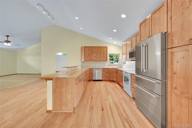 1624 Daphne St, Broomfield, CO 80020 - kitchen featuring stainless steel appliances, a peninsula, lofted ceiling, light wood finished floors, and ceiling fan