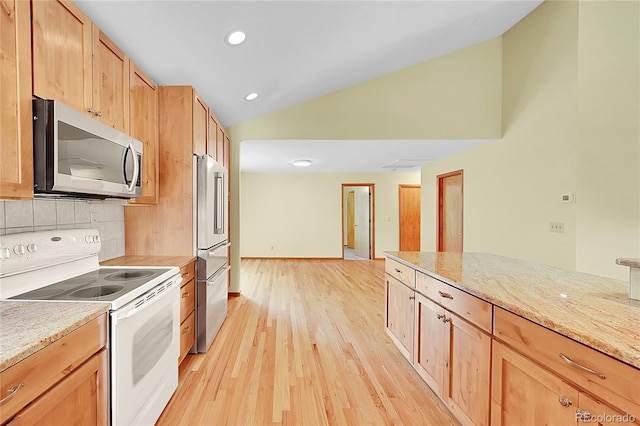 1624 Daphne St, Broomfield, CO 80020 - kitchen with stainless steel appliances, vaulted ceiling, decorative backsplash, light wood-type flooring, and light stone countertops