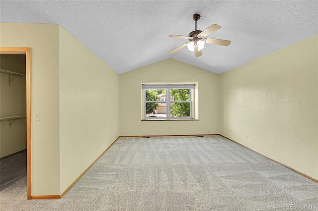 1624 Daphne St, Broomfield, CO 80020 - unfurnished bedroom with a spacious closet, carpet, lofted ceiling, a textured ceiling, and a ceiling fan