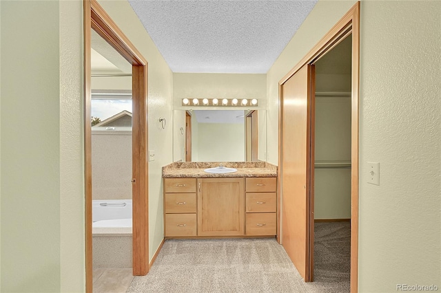 1624 Daphne St, Broomfield, CO 80020 - full bathroom with vanity, a bath, and a textured ceiling