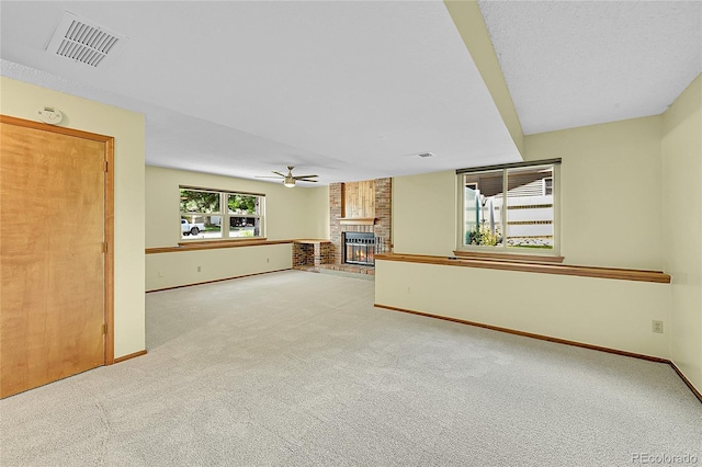 1624 Daphne St, Broomfield, CO 80020 - unfurnished living room featuring carpet flooring, a brick fireplace, and a ceiling fan