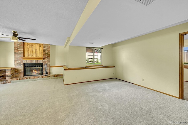 1624 Daphne St, Broomfield, CO 80020 - unfurnished living room featuring carpet flooring, a ceiling fan, a brick fireplace, and a textured ceiling