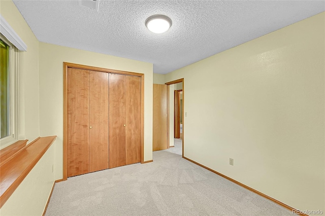 1624 Daphne St, Broomfield, CO 80020 - unfurnished bedroom with a closet, light carpet, and a textured ceiling