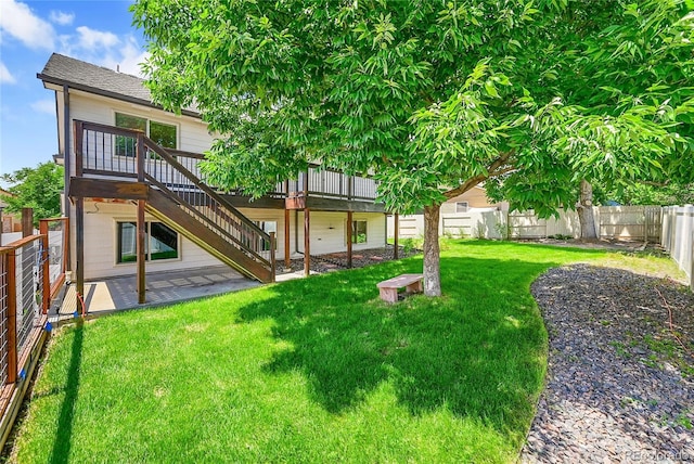 1624 Daphne St, Broomfield, CO 80020 - back of property featuring a fenced backyard, a wooden deck, a patio area, and stairs