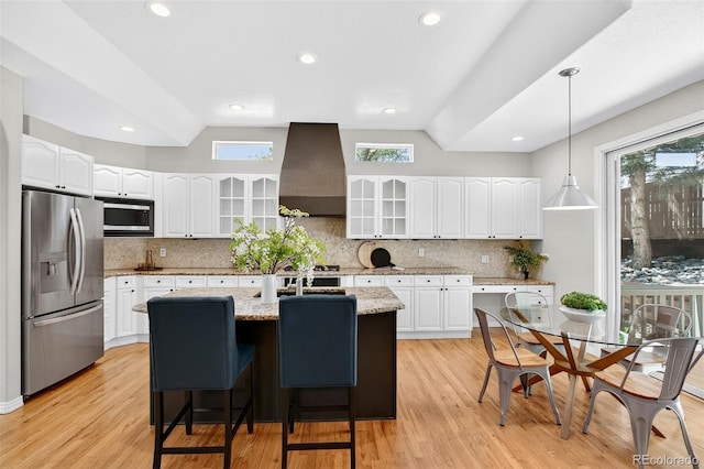 4501 Whitehall Ln, Highlands Ranch, CO 80126 - kitchen with appliances with stainless steel finishes, custom range hood, glass insert cabinets, lofted ceiling, and decorative backsplash