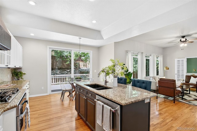 4501 Whitehall Ln, Highlands Ranch, CO 80126 - kitchen with stainless steel appliances, light wood finished floors, healthy amount of natural light, pendant lighting, and recessed lighting