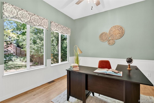 4501 Whitehall Ln, Highlands Ranch, CO 80126 - home office with wainscoting, wood finished floors, and a ceiling fan