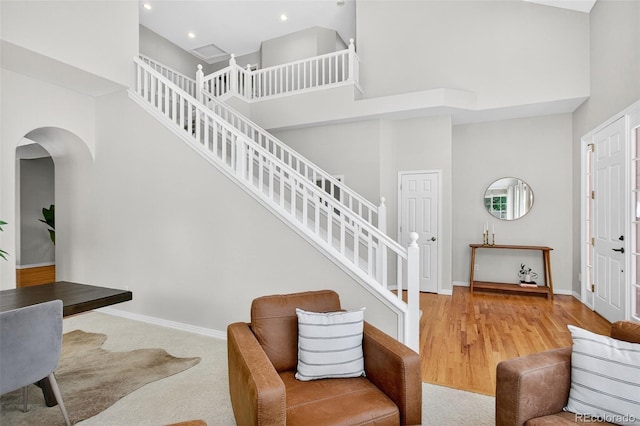 4501 Whitehall Ln, Highlands Ranch, CO 80126 - entrance foyer featuring a high ceiling, arched walkways, recessed lighting, stairway, and wood finished floors
