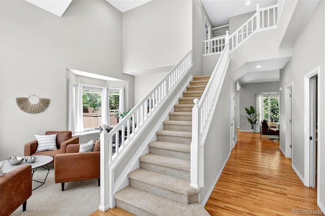 4501 Whitehall Ln, Highlands Ranch, CO 80126 - stairs with wood finished floors, a high ceiling, plenty of natural light, and recessed lighting