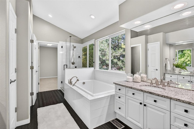 4501 Whitehall Ln, Highlands Ranch, CO 80126 - full bathroom with vanity, a stall shower, a bath, lofted ceiling, and recessed lighting