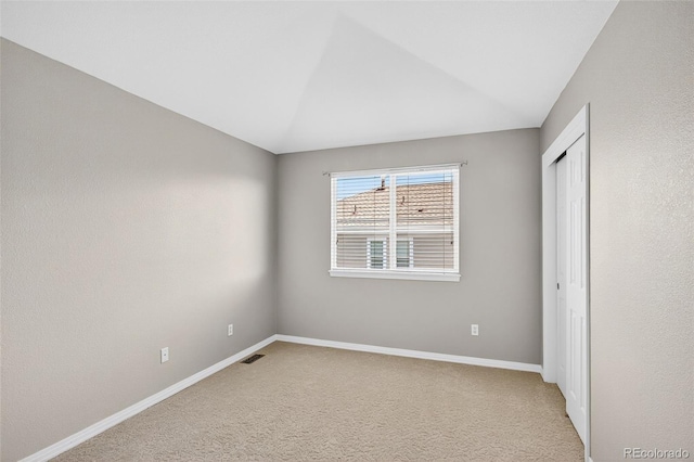 4501 Whitehall Ln, Highlands Ranch, CO 80126 - unfurnished bedroom with light colored carpet, a closet, and vaulted ceiling