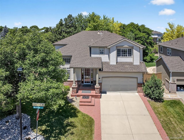 4501 Whitehall Ln, Highlands Ranch, CO 80126 - view of front of house featuring roof with shingles, driveway, brick siding, and an attached garage